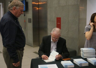Signing a book for writer George O'Brien